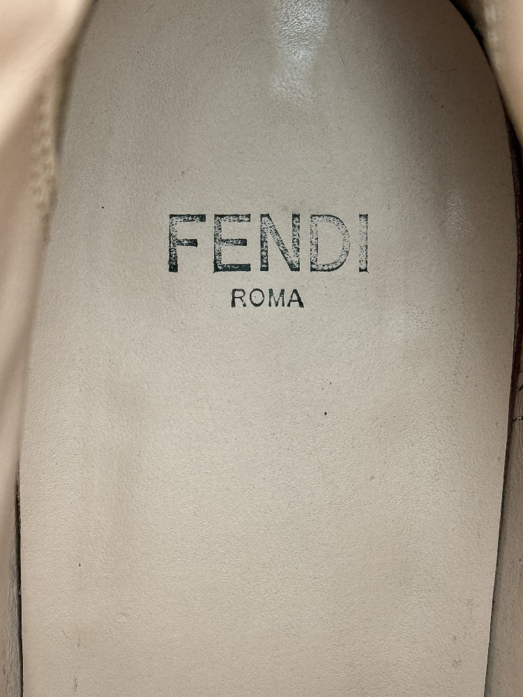 Close-up of a Fendi logo on a beige leather surface