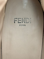 Close-up of a Fendi logo on a beige leather surface